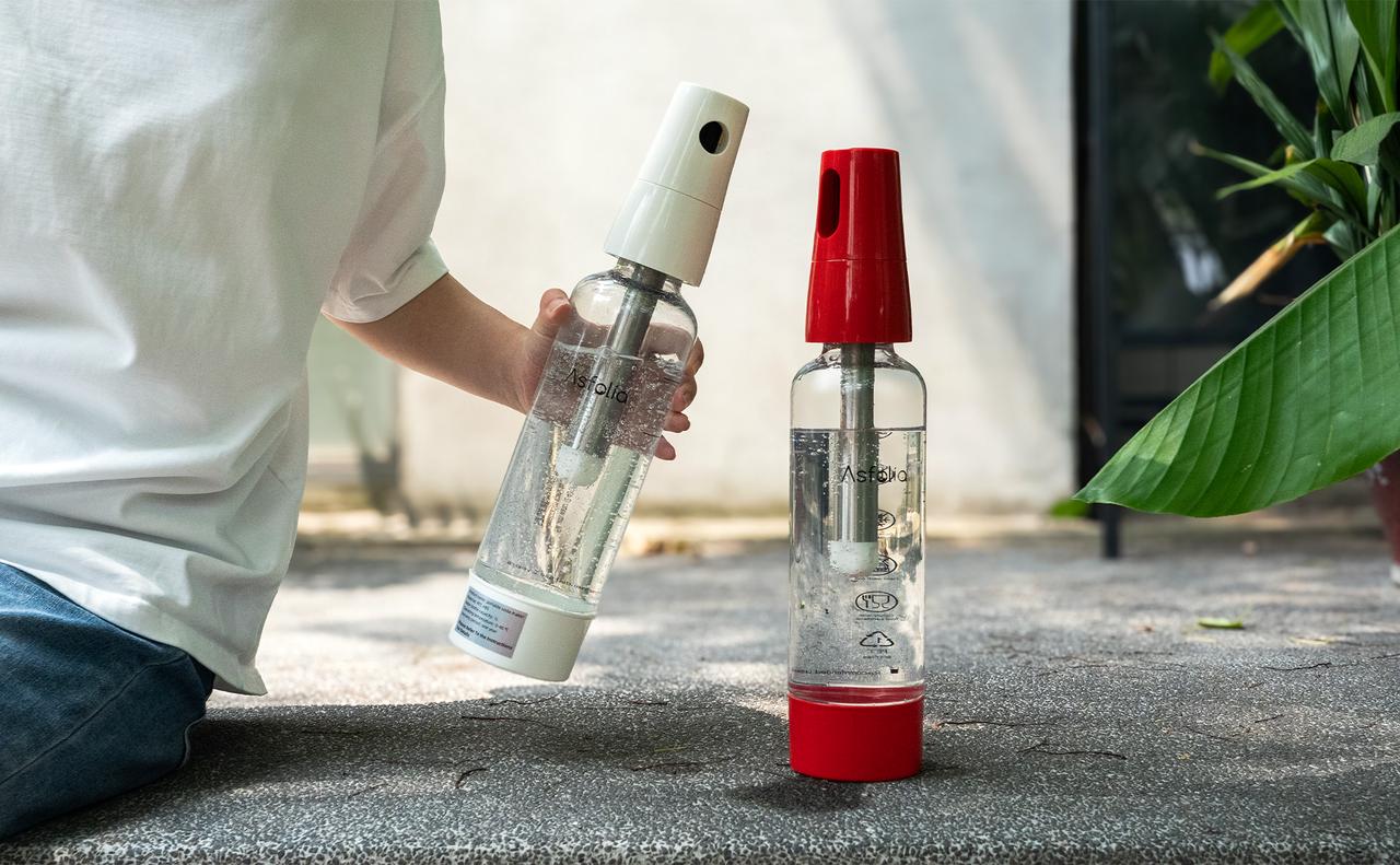  Two Asfolia portable water carbonators, one with a red top and one with a white top, being used outdoors