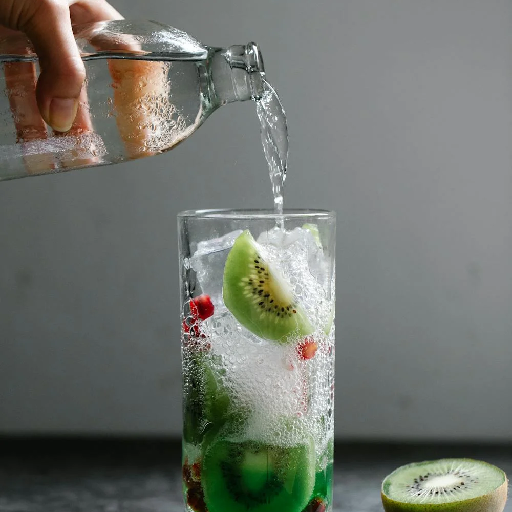 Two elegant glasses of soda water cocktails with garnishes