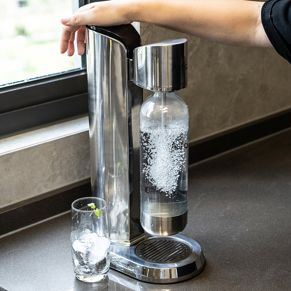 A person using the AGAVE Sparkling Water Maker with a full-metal body